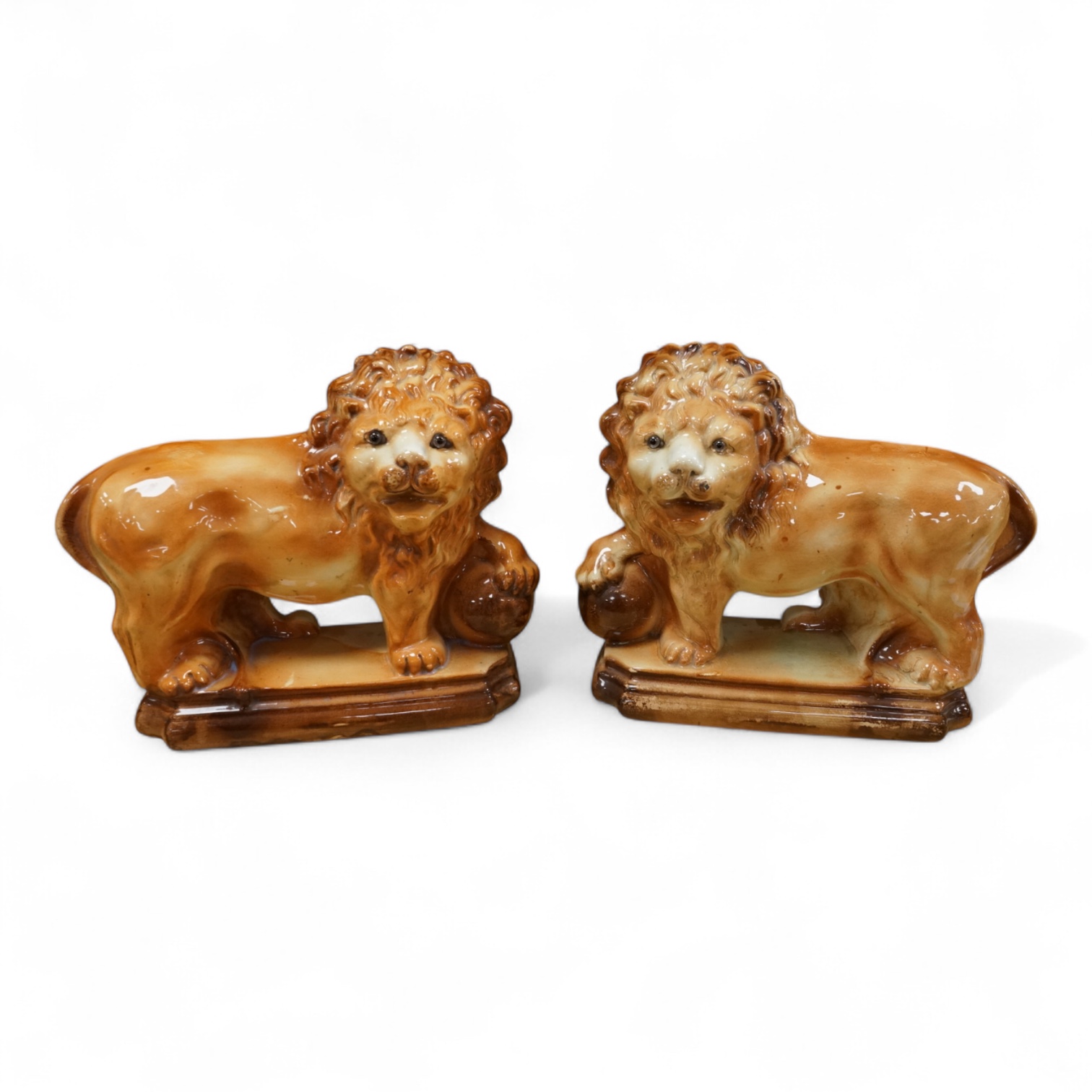 A pair of Staffordshire pottery lions, c.1900, 34cm